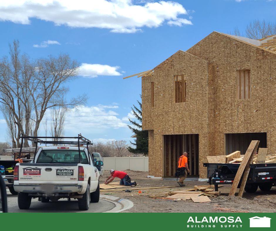 The Backbone of Every Great Build Alamosa Building Supply truck parked in front of a house under construction in Alamosa, Colorado