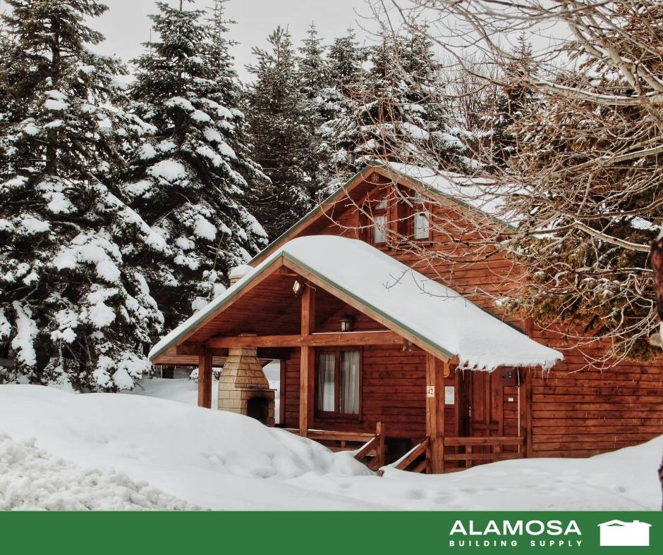 Cabin in the Flagstaff mountains covered in snow and surrounded by pine trees