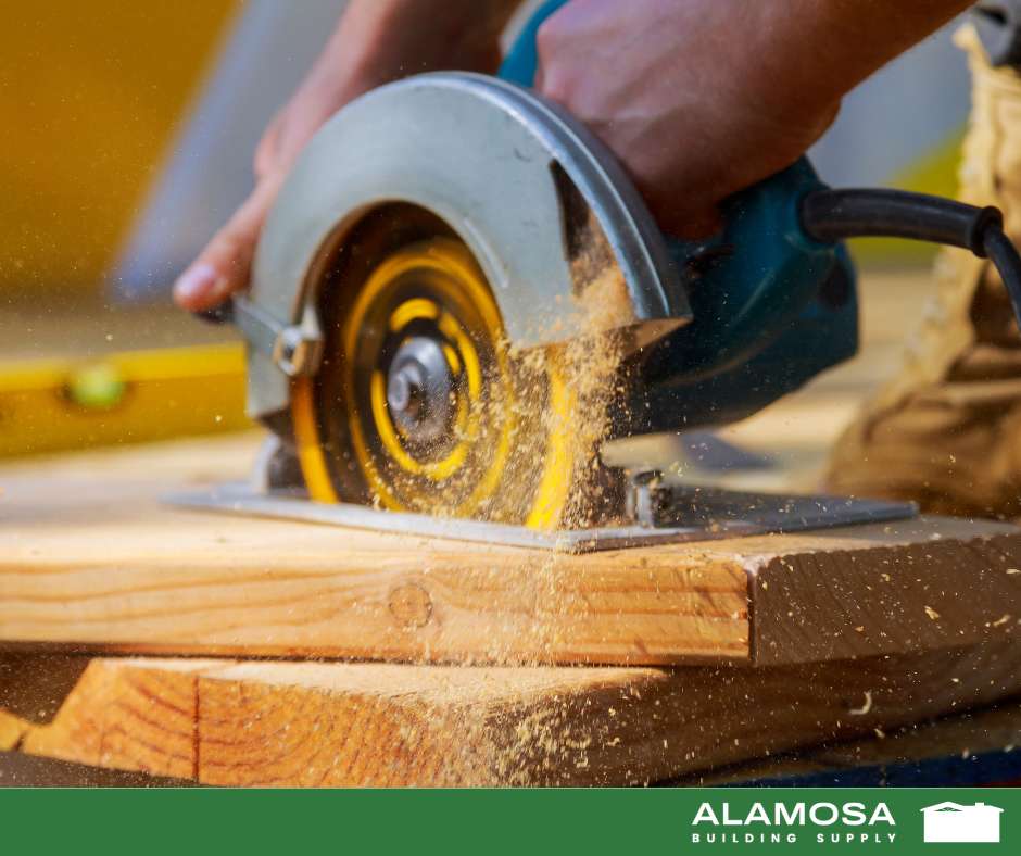 Man using circular saw to cut through piece of wood