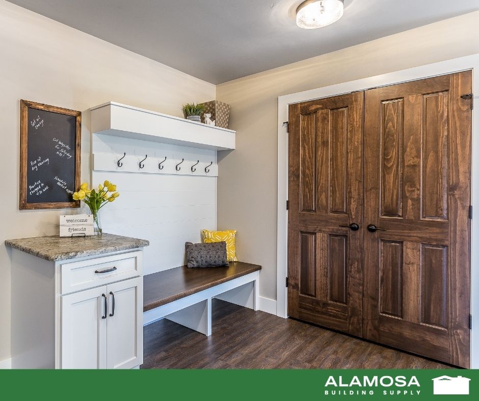 White shiplap mudroom bench with granite counter and wall hooks, perfect for functional entryway storage ideas in San Luis Valley homes.